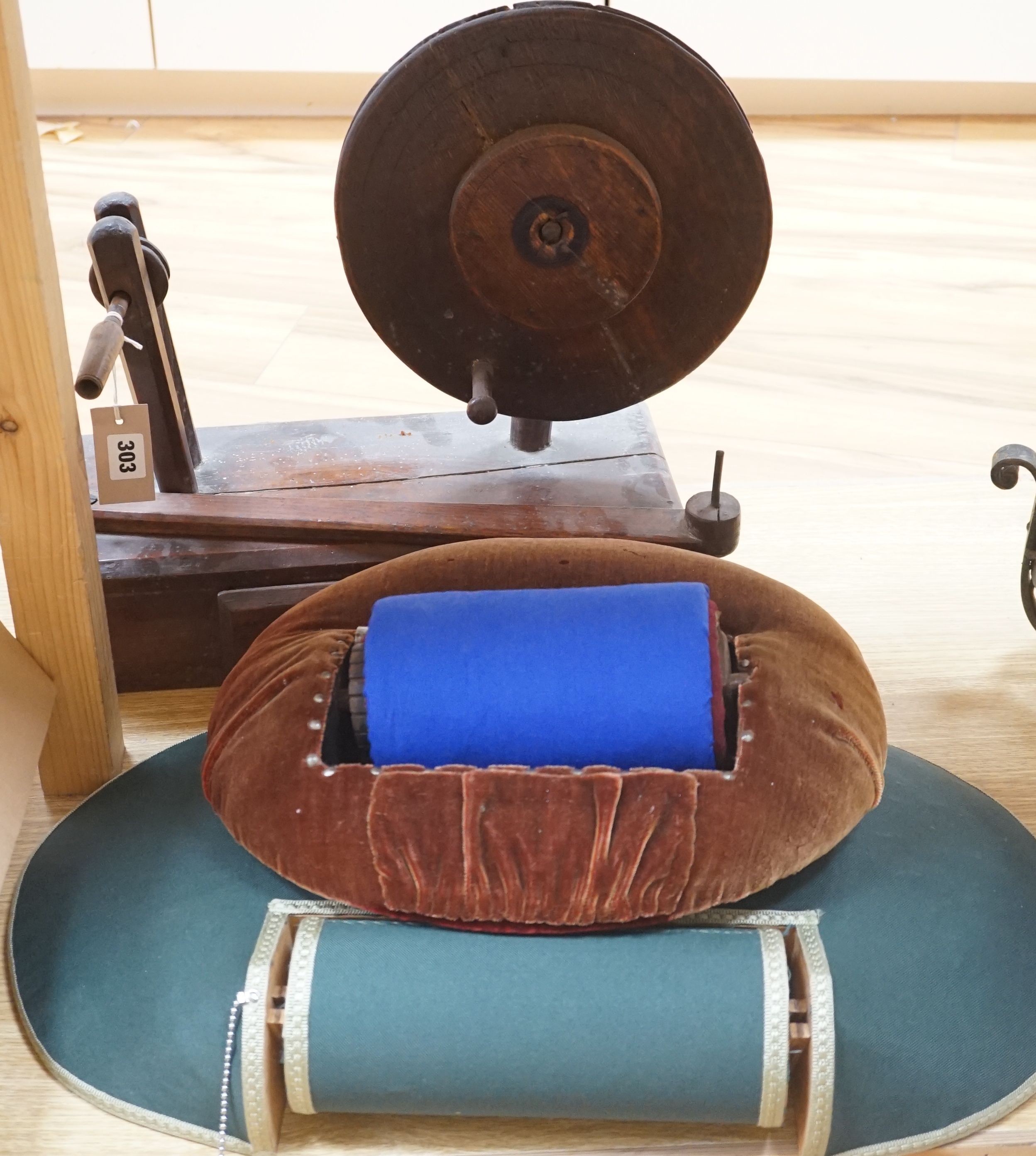 An antique lacemaker's pillow and a modern lacemaker's pillow and a lacemaker's bobbin winder